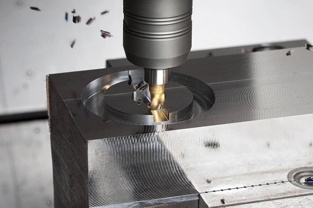A drill bit on milling machine spindle creating hole on stainless steel
