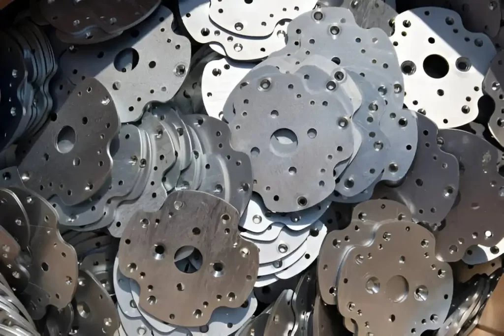 Close-up of stamped aluminum parts showing detailed shapes and features.