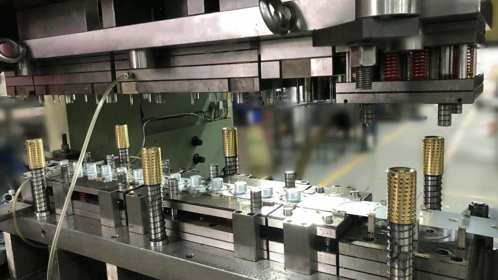A close-up view of a progressive die with multiple operation setups.