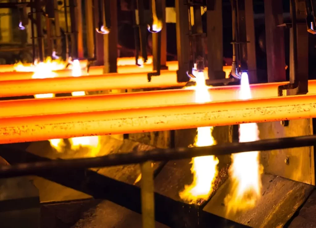 Steel rods are being heated at high temperatures during the annealing process.