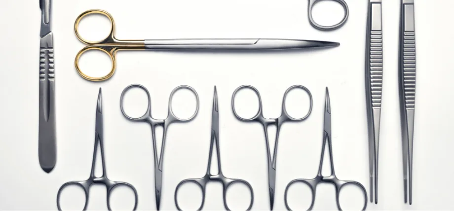 multiple scissors and tweezers made of steel on a white background