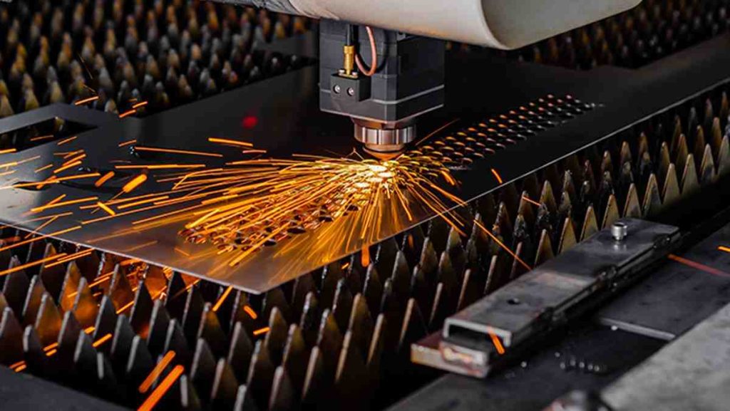 Close-up of a fiber laser cutting machine actively cutting a metal sheet.