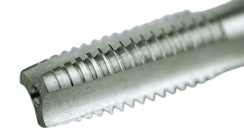 A close-up view of a thread tap. It shows its intricate details and sharp threads.