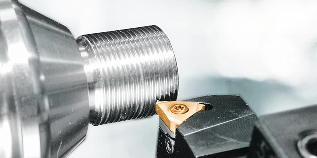 A close-up view of the tool refining the threads