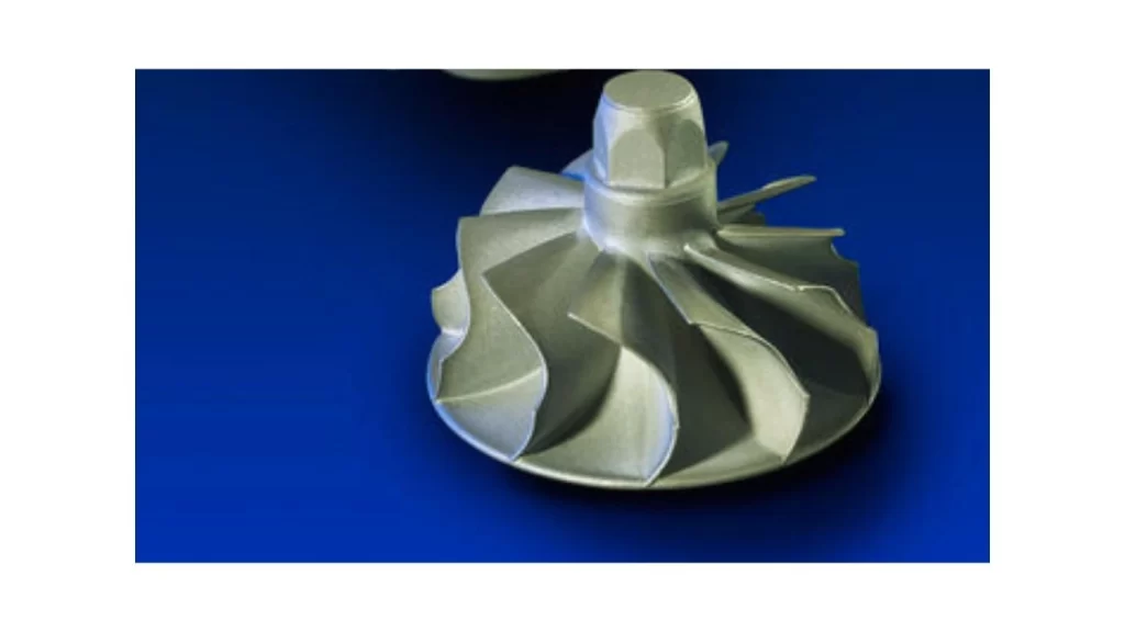 The image shows twisted blade components made of titanium aluminide used in an engine.