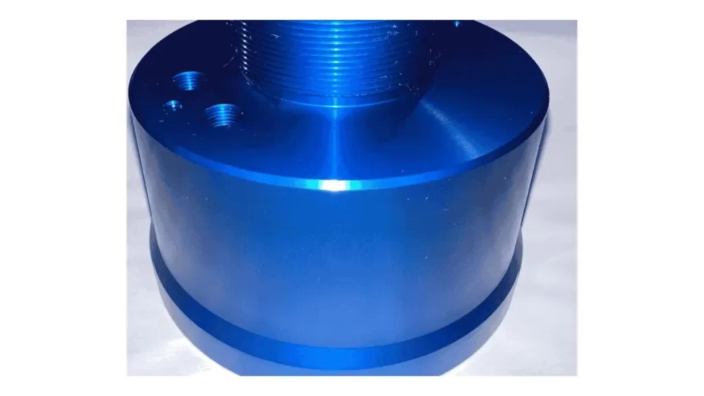 A close-up of a blue, vibrant, and shiny Type II anodized surface showing its thickness.