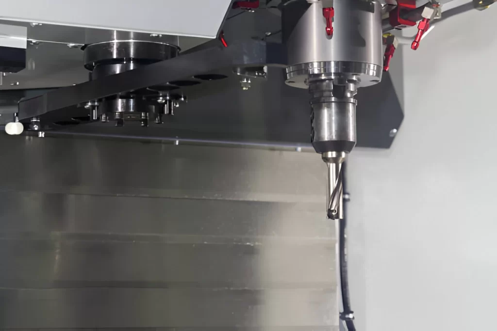 Vertical machining center with tool in position.
