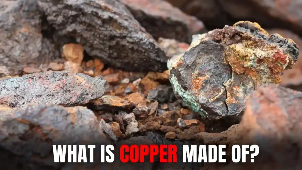 A close-up of rough copper ore with a green patina