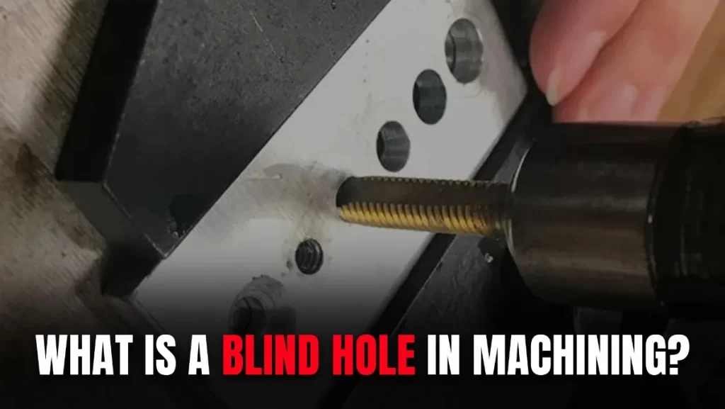 A close-up of using a tool to tap a threaded hole in a metal block.