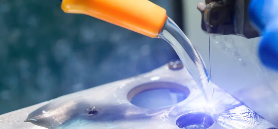 Wire edm cutting metal with deionized water flowing over it