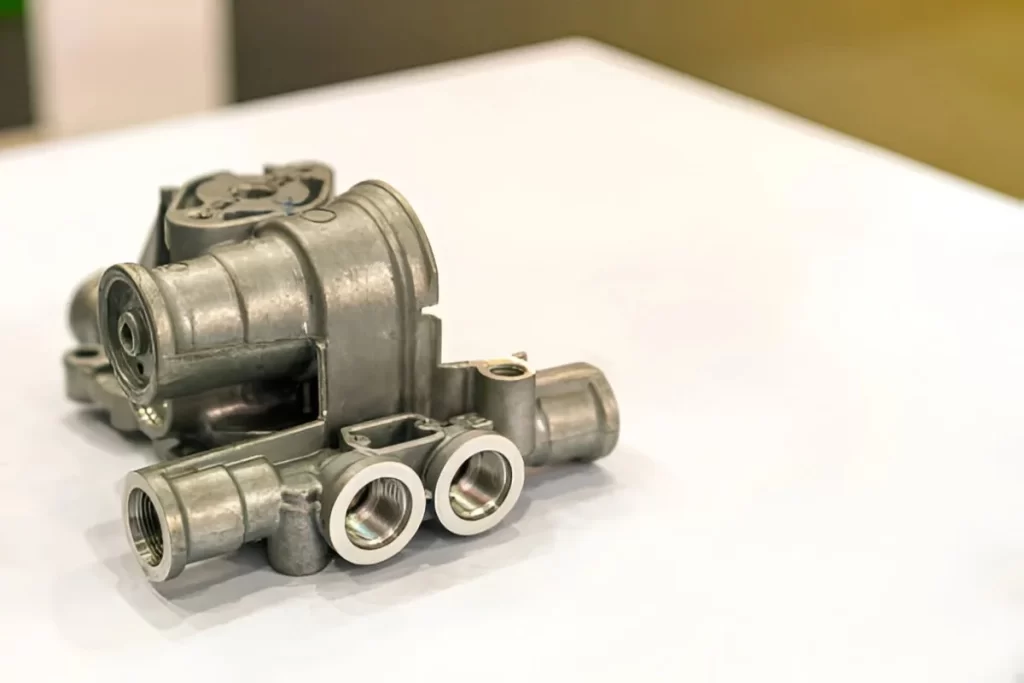 Zinc cast automotive part displayed with visible surface details.
