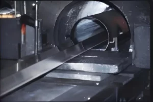a large scale aluminum extruder is extruding profiles