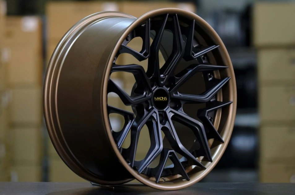 An image of a brown and satin black car wheel barrel placed on a surface