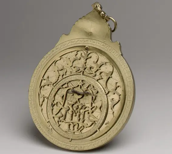A circular brass plate with intricate decorations