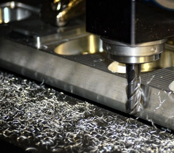 An image of a CNC milling tool removing material from the edge of a workpiece