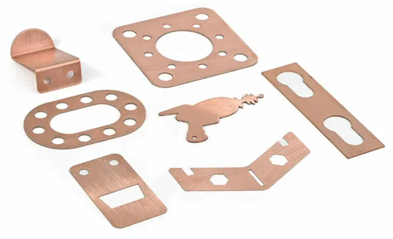 Copper laser-cut metal parts in various shapes.