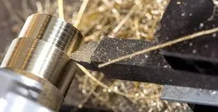 Close-up of a CNC machining tool and a working piece of brass