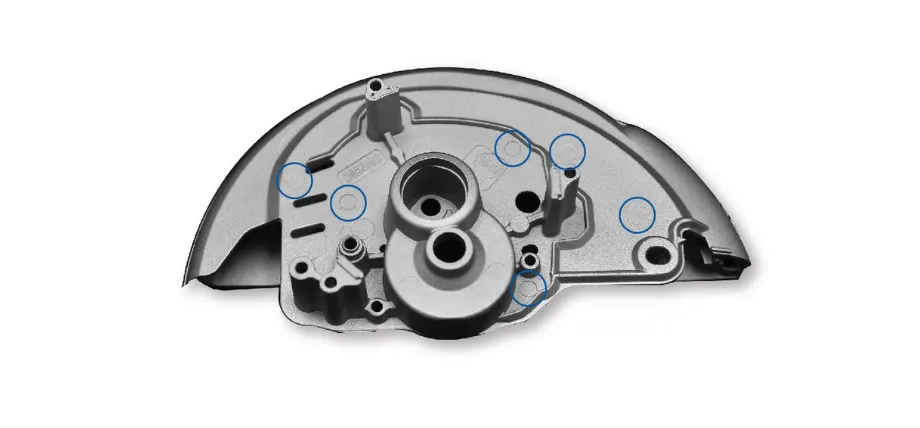 black plastic part with round pin marks circled in blue