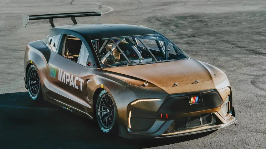 Bronze racing concept car with rear wing and roll cage on test track