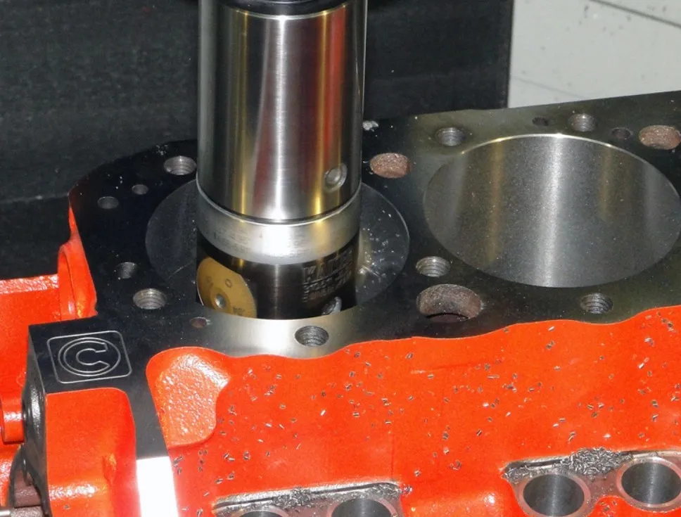 A side milling cutter machining a cylinder bore for a red engine block