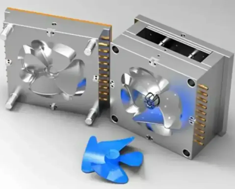 An open injection mold with a blue plastic fan blade functional prototype in the foreground.
