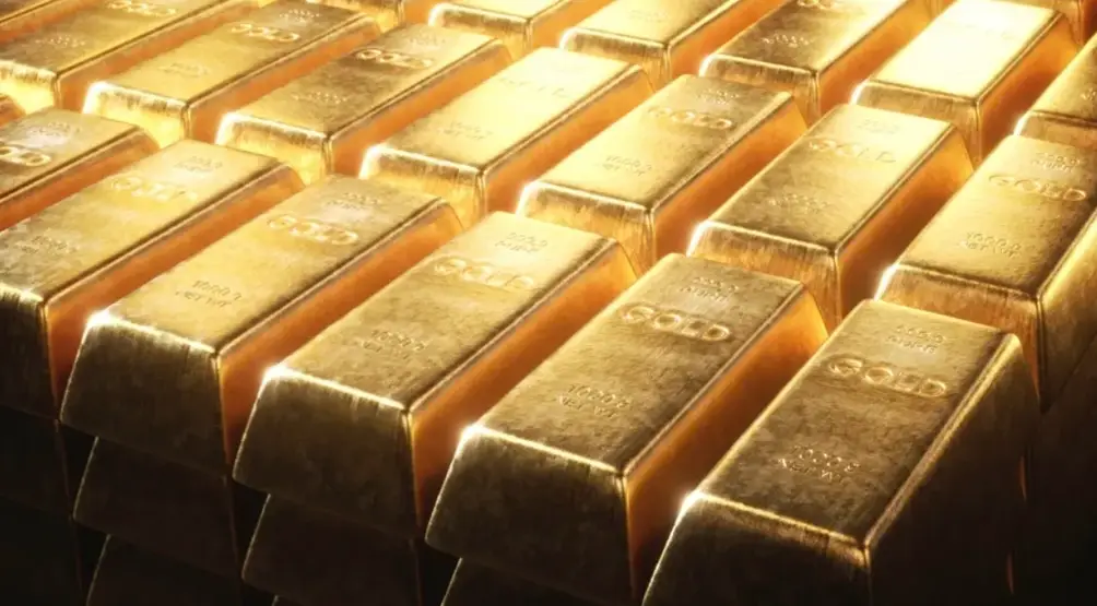 A closeup of shiny bars of gold arranged neatly