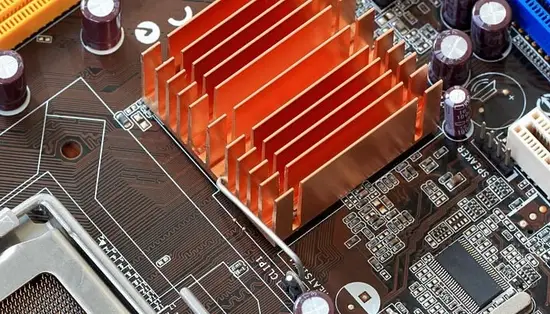 A motherboard showing a copper heat sink and other components