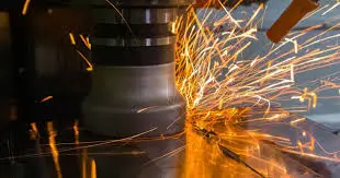 Metal machining with sparks flying.