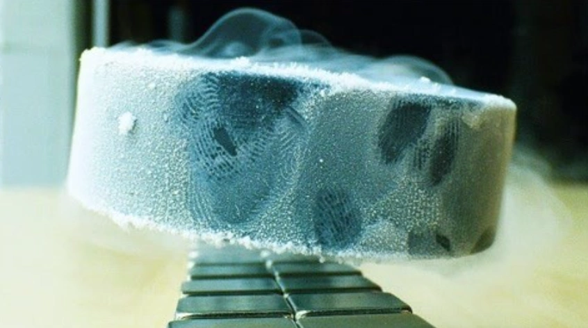 Diamond-coated CNC cutting tool machining a block with liquid nitrogen cryogenic cooling, creating visible frost