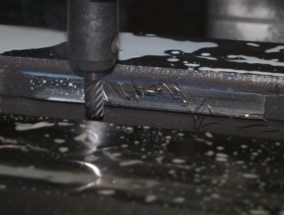 A close-up image of a side milling cutter and a 1018 steel block