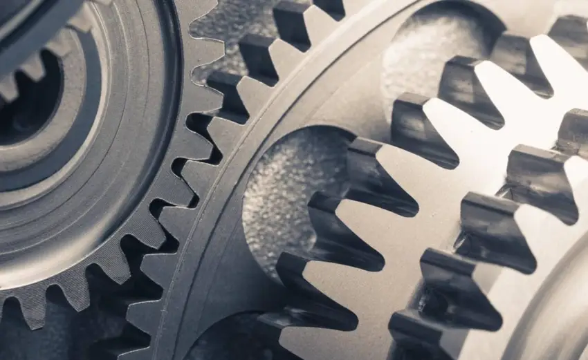 A closeup image of gears of medium carbon steel meshing