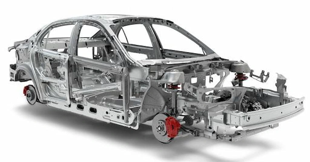 Monocoque frame, showing hood, side bars, axle shafts, and many other car systems assembled together.