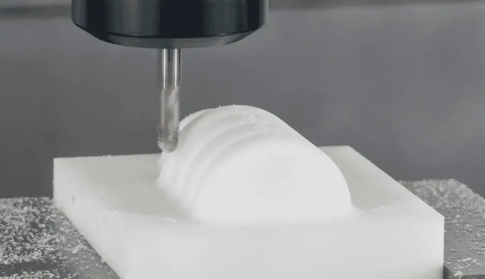 CNC machining of a white nylon plastic part