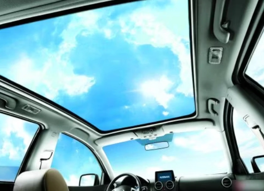 An image of a view of the sky through a polycarbonate sunroof of a car