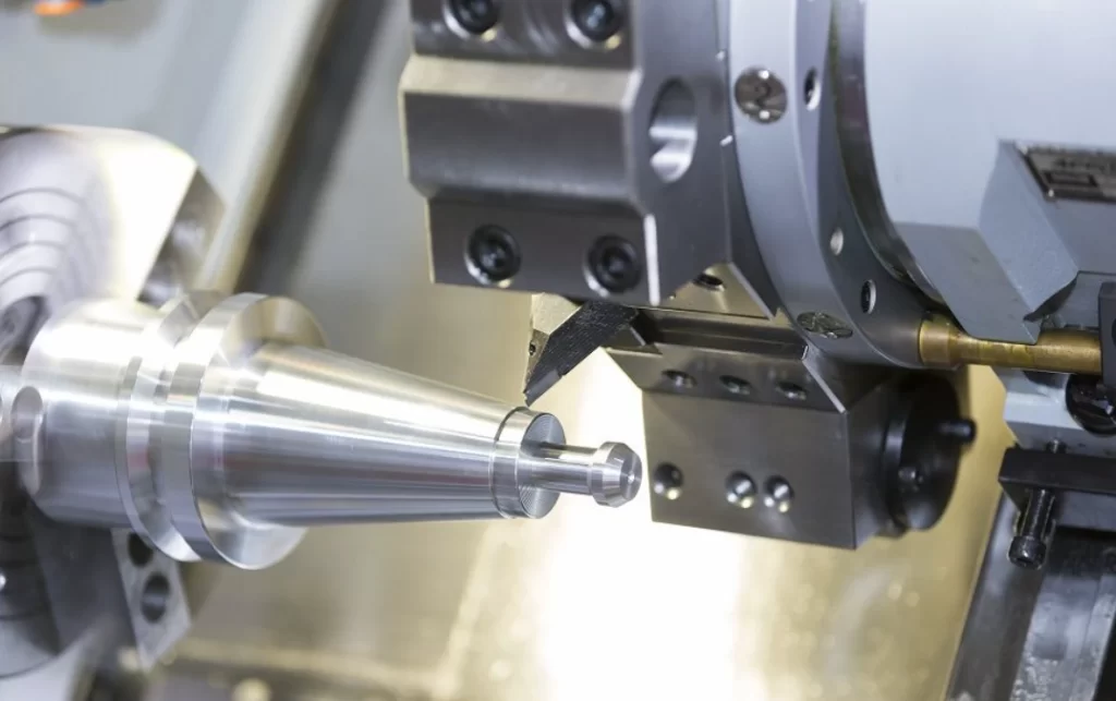 CNC lathe cutting tool machining a metal shaft workpiece
