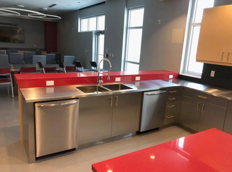 A modern kitchen featuring stainless steel cabinets pulls