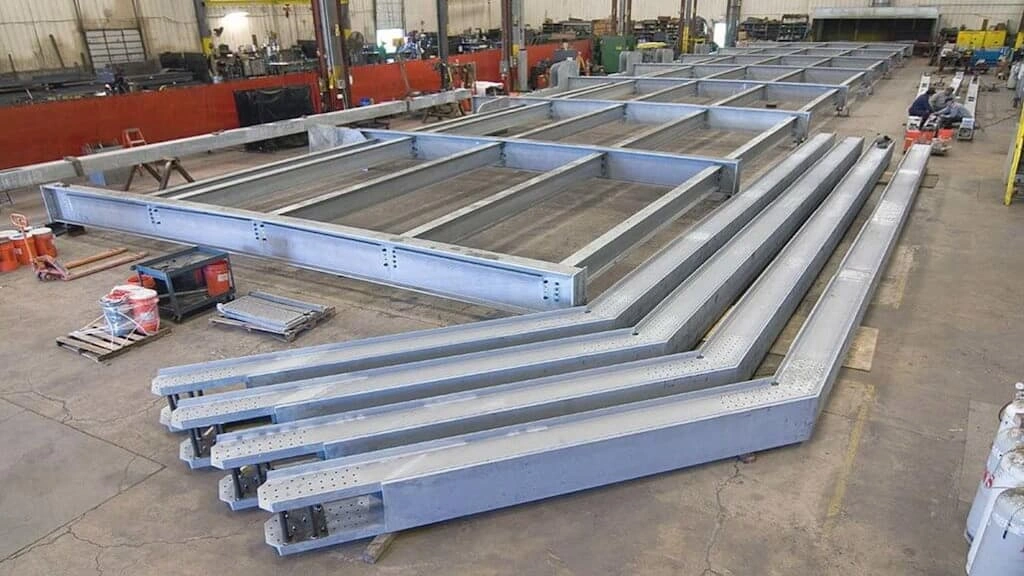 Coated steel beams made with heavy structural fabrication
