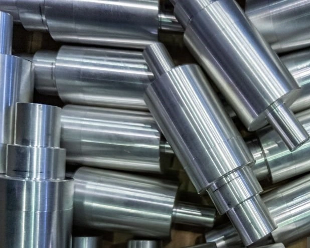 A closeup image of many shiny surface finished metal shafts