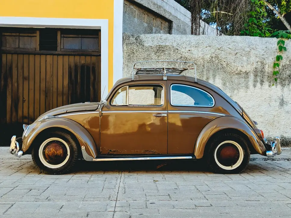 A blown colored Teflon coated vintage car on road