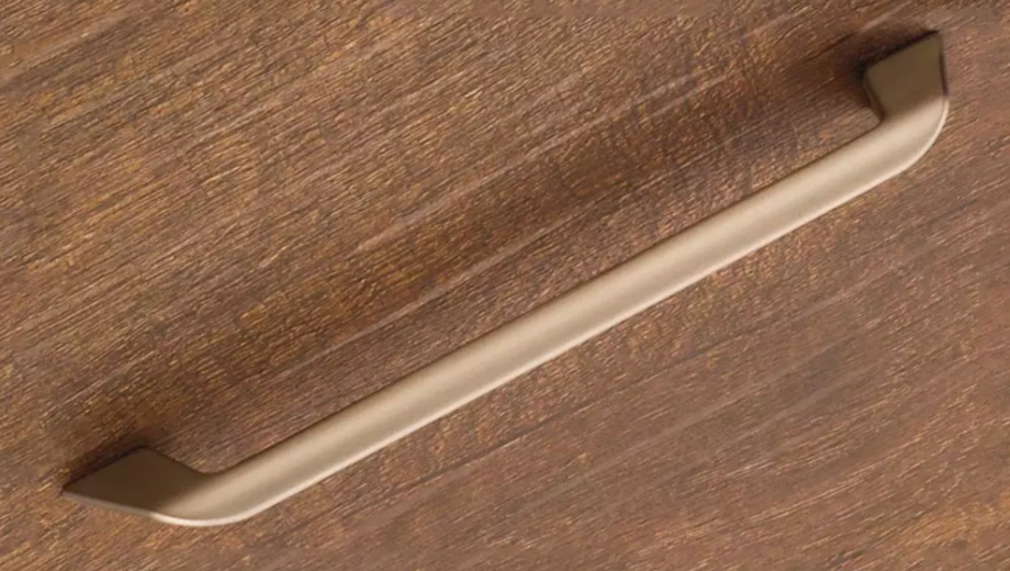 Zinc alloy cabinet handle mounted on a wooden surface