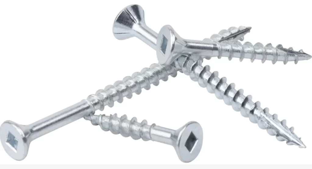 Four shiny zinc-plated screws on a white background